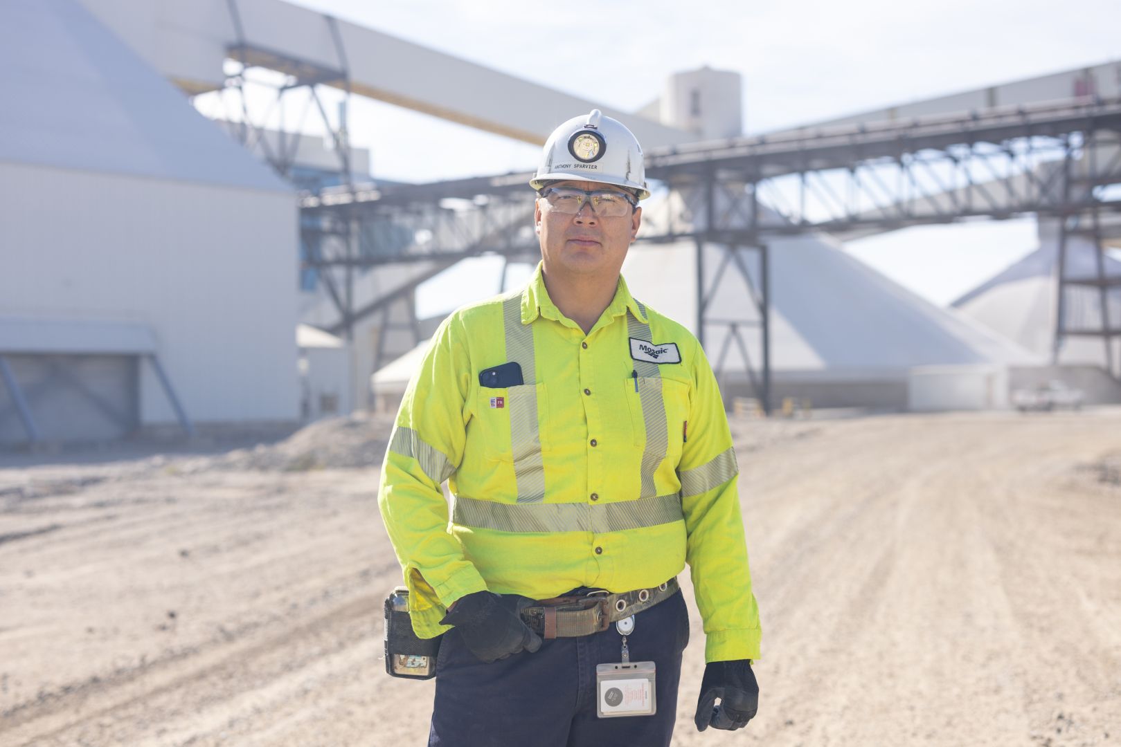 Mosaic Employee posing in front of manufacturing plant